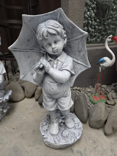 Stature- boy with umbrella.